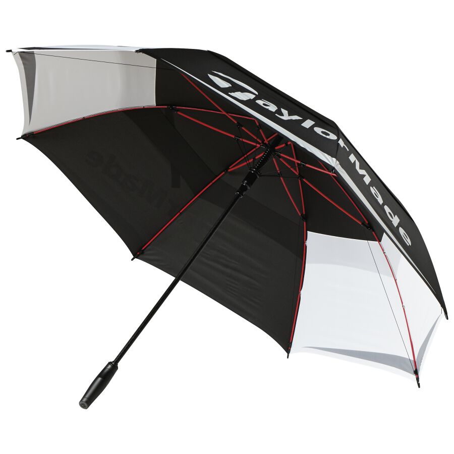 Vented 64-inch golf umbrella ready to start shading a stand bag on a sunny tee box
