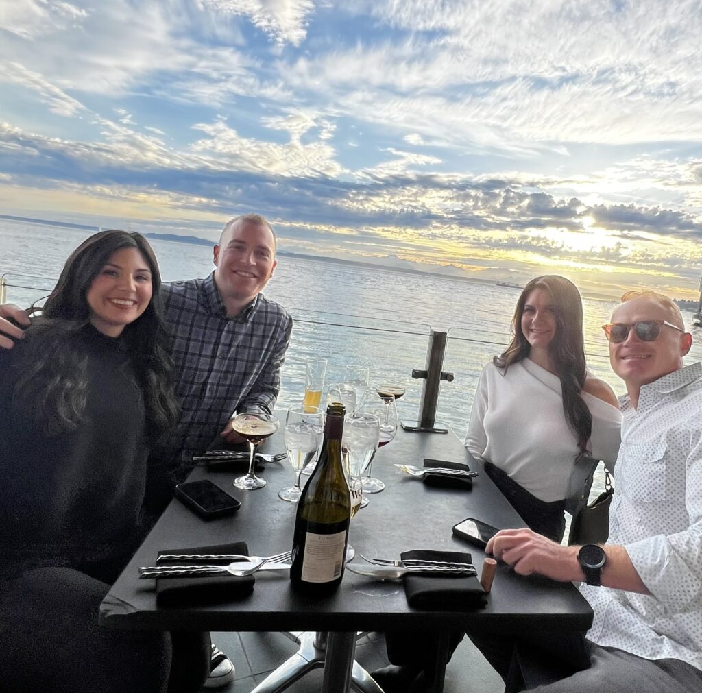 Golden hour over Puget Sound from Six Seven restaurant table at Edgewater Hotel.