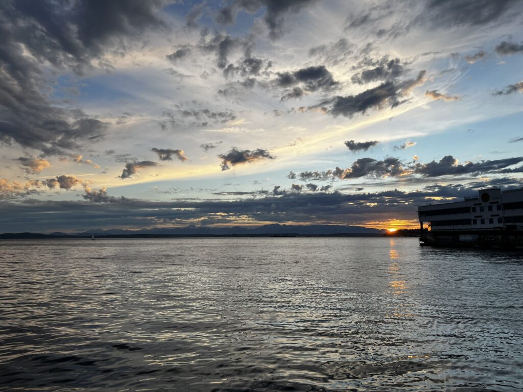 Golden hour over Puget Sound from Six Seven restaurant table at Edgewater Hotel.