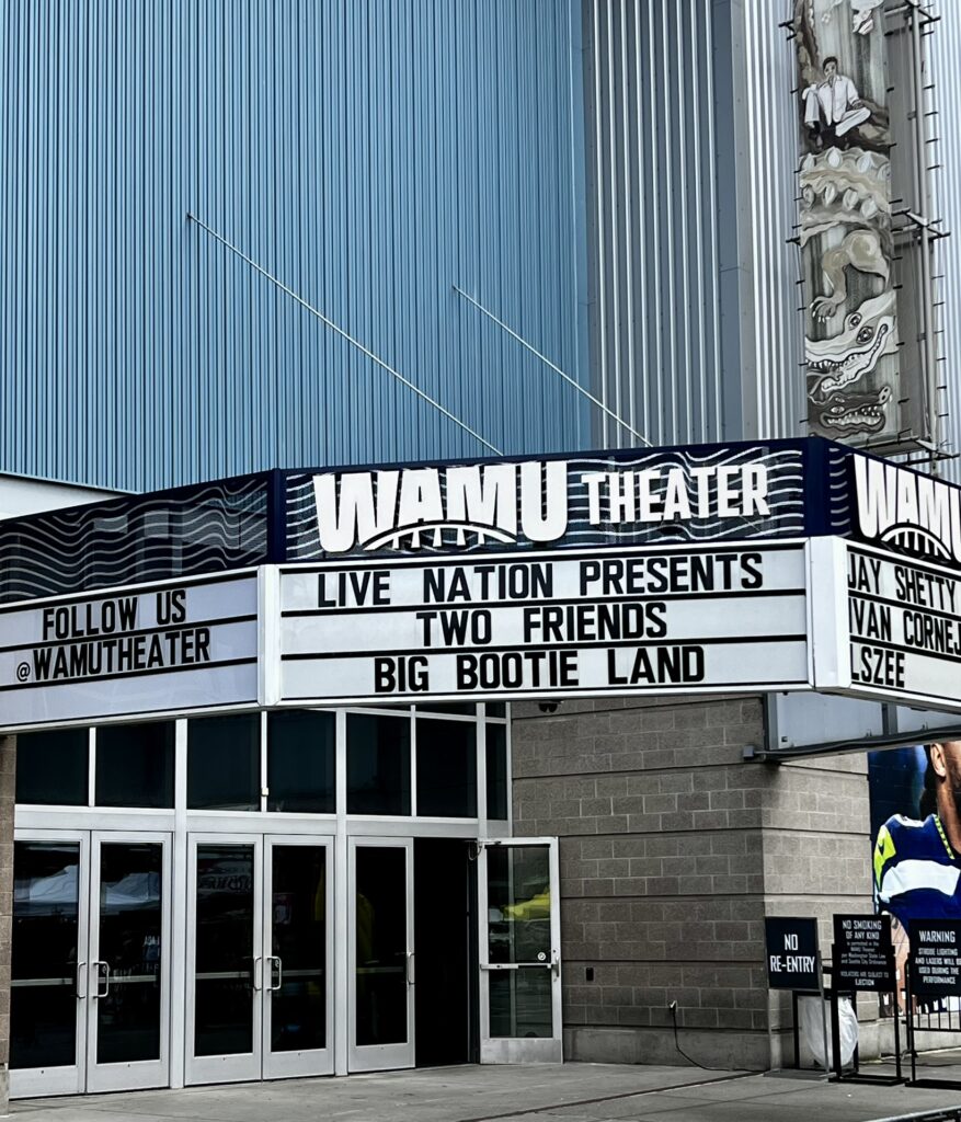 View from outside the WaMu Theater in front of a marquee that reads off the billing for the Two Friends show